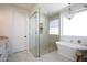 Luxurious bathroom featuring modern tub, glass shower, and elegant chandelier at 542 E Hayward Ave, Phoenix, AZ 85020