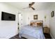 Cozy bedroom with decorative pillows, ceiling fan, hardwood floors and an ensuite bathroom at 542 E Hayward Ave, Phoenix, AZ 85020