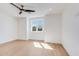 Bright, empty bedroom with natural light, hardwood floors, and white trim at 542 E Hayward Ave, Phoenix, AZ 85020