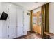 Bright entryway featuring double doors with glass panels, a closet, hardwood floors and gold velvet drapes at 542 E Hayward Ave, Phoenix, AZ 85020