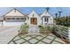 Charming white brick home with a well-manicured front yard and a white picket fence at 542 E Hayward Ave, Phoenix, AZ 85020