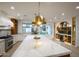 Spacious kitchen island with marble countertops and brass pendant lighting at 542 E Hayward Ave, Phoenix, AZ 85020