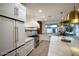 Bright, white kitchen with stainless steel appliances, marble countertops, and modern fixtures at 542 E Hayward Ave, Phoenix, AZ 85020