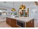 Kitchen island with marble countertop, microwave and wine refrigerator at 542 E Hayward Ave, Phoenix, AZ 85020