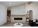 Cozy living room featuring a modern fireplace, built-in shelving, and comfortable seating at 542 E Hayward Ave, Phoenix, AZ 85020