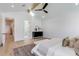 Spacious bedroom featuring hardwood floors and a view into the ensuite bath at 542 E Hayward Ave, Phoenix, AZ 85020