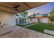 Cozy patio overlooking the pool and backyard, featuring comfortable seating and a stylish wood-paneled ceiling with fan at 542 E Hayward Ave, Phoenix, AZ 85020