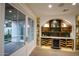 Wine cellar and bar area with custom shelves and adjacent to outdoor space at 542 E Hayward Ave, Phoenix, AZ 85020