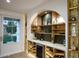 Elegant wine cellar featuring custom shelving, stone countertop, and a cooler at 542 E Hayward Ave, Phoenix, AZ 85020