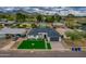 Stunning aerial view of the home with mountain views, showcasing the well-maintained lawn and paved driveway at 6719 N 10Th Pl, Phoenix, AZ 85014