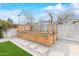 Backyard with artificial turf, wooden planter box, and gravel space with stepping stones to access at 6719 N 10Th Pl, Phoenix, AZ 85014