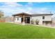 Home showcasing an artificial turf backyard, mature trees, and a covered patio for outdoor living at 6719 N 10Th Pl, Phoenix, AZ 85014