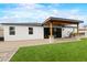 A covered patio extends the living space to a backyard featuring artificial turf, and mature trees at 6719 N 10Th Pl, Phoenix, AZ 85014