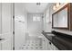 Bright bathroom with white subway tiles, black fixtures, and vintage-style black and white mosaic tile flooring at 6719 N 10Th Pl, Phoenix, AZ 85014