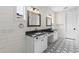 Modern bathroom featuring double vanity sinks, patterned tile flooring, and shiplap walls at 6719 N 10Th Pl, Phoenix, AZ 85014