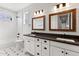 Bright bathroom with dual vanity, framed mirrors, subway tile, and stylish fixtures at 6719 N 10Th Pl, Phoenix, AZ 85014