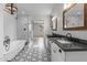 Stylish bathroom with double vanity, soaking tub, glass shower, and patterned tile floors at 6719 N 10Th Pl, Phoenix, AZ 85014