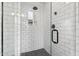 Modern shower with a glass door, matte black hardware, white subway tiles, and a mosaic shower floor at 6719 N 10Th Pl, Phoenix, AZ 85014