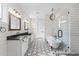 Spacious bathroom featuring a double vanity, soaking tub, shower, and stylish lighting at 6719 N 10Th Pl, Phoenix, AZ 85014