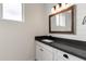 Stylish bathroom vanity with dark countertop, white cabinetry, and modern fixtures at 6719 N 10Th Pl, Phoenix, AZ 85014