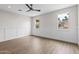 Bright bedroom with wood laminate flooring, white trim, and plenty of natural light from three windows at 6719 N 10Th Pl, Phoenix, AZ 85014