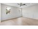 Bright bedroom featuring wood-look flooring, paneled walls, and natural light from the large windows at 6719 N 10Th Pl, Phoenix, AZ 85014