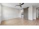 Light-filled bedroom with wood-look flooring, a sliding barn door, and modern ceiling fan at 6719 N 10Th Pl, Phoenix, AZ 85014