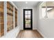 Bright entryway featuring a reclaimed wood accent wall, stylish bench, and a view of the front yard at 6719 N 10Th Pl, Phoenix, AZ 85014