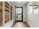 Bright entryway featuring a reclaimed wood accent wall, stylish bench, and a view of the front yard at 6719 N 10Th Pl, Phoenix, AZ 85014