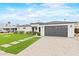 Modern one story home with manicured lawn, walkway, and gray garage door under cloudy sky at 6719 N 10Th Pl, Phoenix, AZ 85014