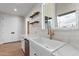 Bright kitchen with a farmhouse sink, marble countertops, and modern fixtures at 6719 N 10Th Pl, Phoenix, AZ 85014