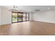 Spacious living room with wood-look floors, a modern light fixture, and large sliding glass doors to the backyard at 6719 N 10Th Pl, Phoenix, AZ 85014