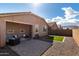 Inviting backyard with covered patio, a defined lawn, and gravel landscaping, ideal for outdoor enjoyment at 7410 S 22Nd Ln, Phoenix, AZ 85041