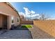 Well-maintained backyard with gravel landscaping, a defined lawn, and a privacy wall at 7410 S 22Nd Ln, Phoenix, AZ 85041