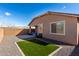 Private backyard featuring a covered patio, small defined lawn, gravel landscaping, and a brick privacy wall at 7410 S 22Nd Ln, Phoenix, AZ 85041