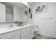 Bright bathroom featuring a double vanity with white cabinets, large mirror, and modern decor at 7410 S 22Nd Ln, Phoenix, AZ 85041