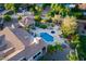 This aerial view showcases the backyard oasis with pool, jacuzzi, and outdoor entertaining spaces at 8270 E Corrine Dr, Scottsdale, AZ 85260