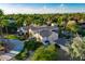 An aerial view of a lush home with palm trees and green grass at 8270 E Corrine Dr, Scottsdale, AZ 85260