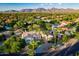 Expansive aerial shot of a lush property with mature trees and mountain views at 8270 E Corrine Dr, Scottsdale, AZ 85260