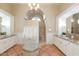 Bright bathroom with dual vanities, granite counters, and a walk-in shower at 8270 E Corrine Dr, Scottsdale, AZ 85260