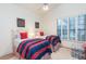 Bright bedroom features two twin beds with red and blue striped bedding and a window with shutters at 8270 E Corrine Dr, Scottsdale, AZ 85260