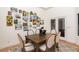 Elegant dining room with wainscoting, decorative art, and seating for six at 8270 E Corrine Dr, Scottsdale, AZ 85260