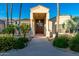 Stunning front entrance with mature landscaping and desert flora provides exceptional curb appeal at 8270 E Corrine Dr, Scottsdale, AZ 85260