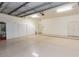 Spacious three car garage featuring painted floors, white walls, and storage at 8270 E Corrine Dr, Scottsdale, AZ 85260