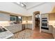 Bright kitchen features granite countertops, stainless steel appliances, and terra cotta tile flooring at 8270 E Corrine Dr, Scottsdale, AZ 85260