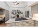 Well-lit kitchen features granite countertops, a cooktop, and white cabinets at 8270 E Corrine Dr, Scottsdale, AZ 85260