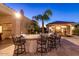 Outdoor kitchen and bar area is perfect for entertaining with seating for six at 8270 E Corrine Dr, Scottsdale, AZ 85260