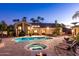 Backyard oasis with a large pool, spa, and palm trees for the ultimate outdoor living experience at 8270 E Corrine Dr, Scottsdale, AZ 85260