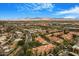 Gorgeous aerial view of the community, highlighting the red-tile roofs, winding roads, and mountain views at 8653 E Royal Palm Rd # 1006, Scottsdale, AZ 85258