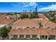 Aerial view of tiled roofs and palm trees shows a community with attached garages at 8653 E Royal Palm Rd # 1006, Scottsdale, AZ 85258